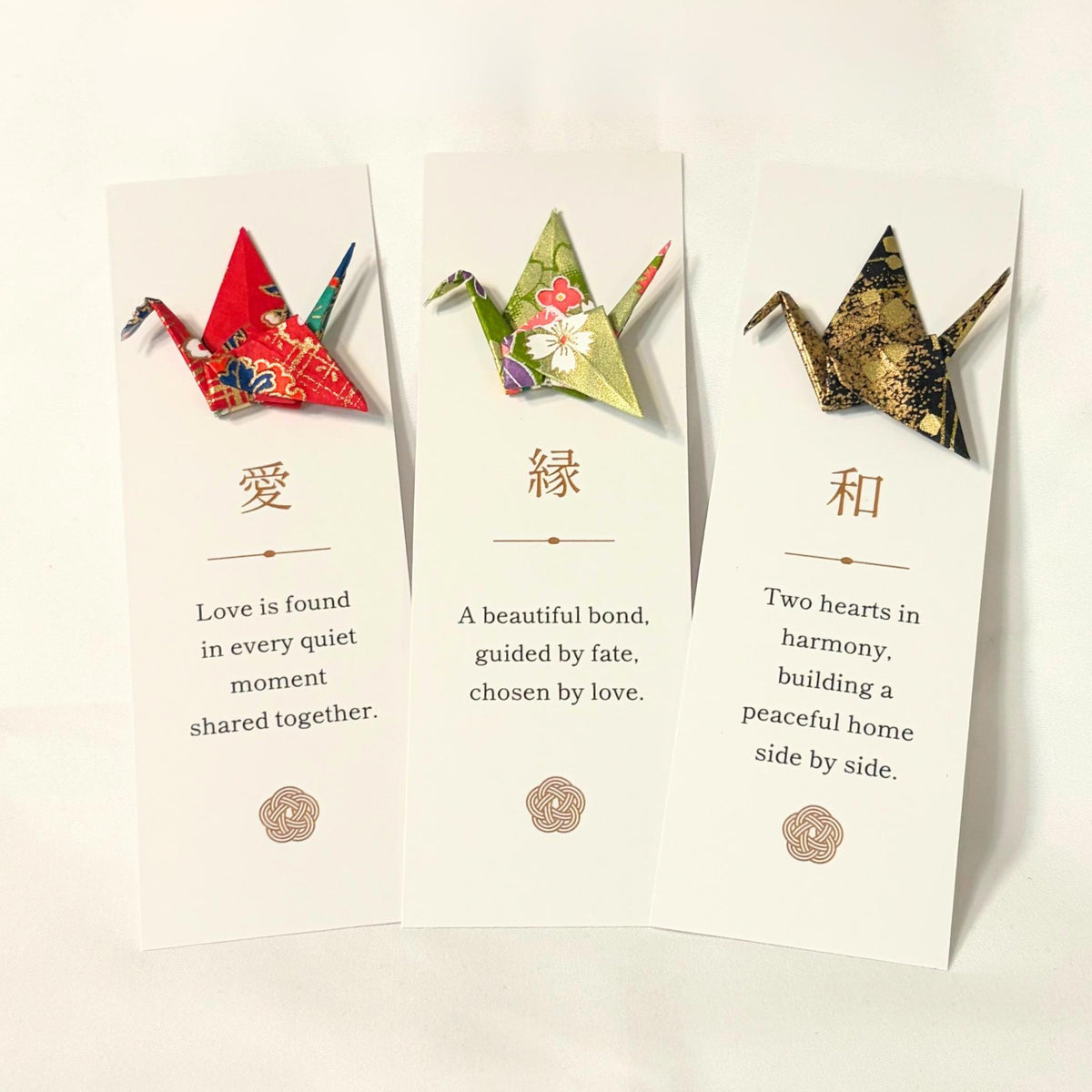 Close-up of an origami crane folded from patterned washi on a bookmark