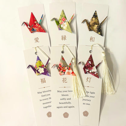 Origami crane kanji bookmark held in the hand for scale
