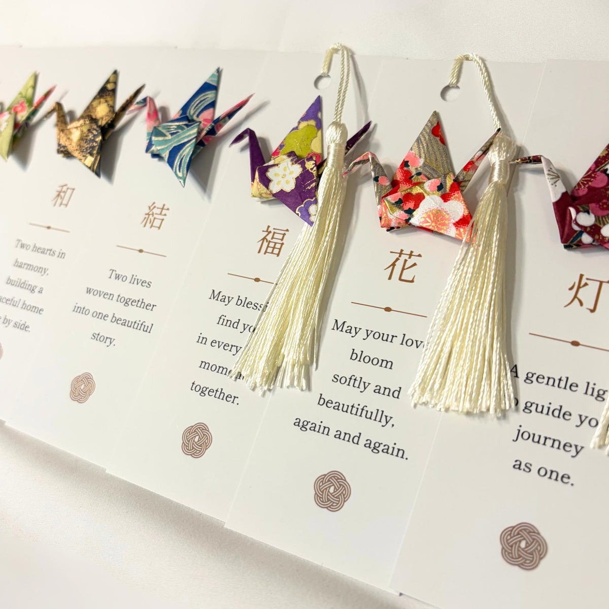 Origami crane bookmarks arranged as wedding guest gifts
